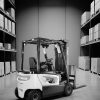 black and white image of forklift in a warehouse